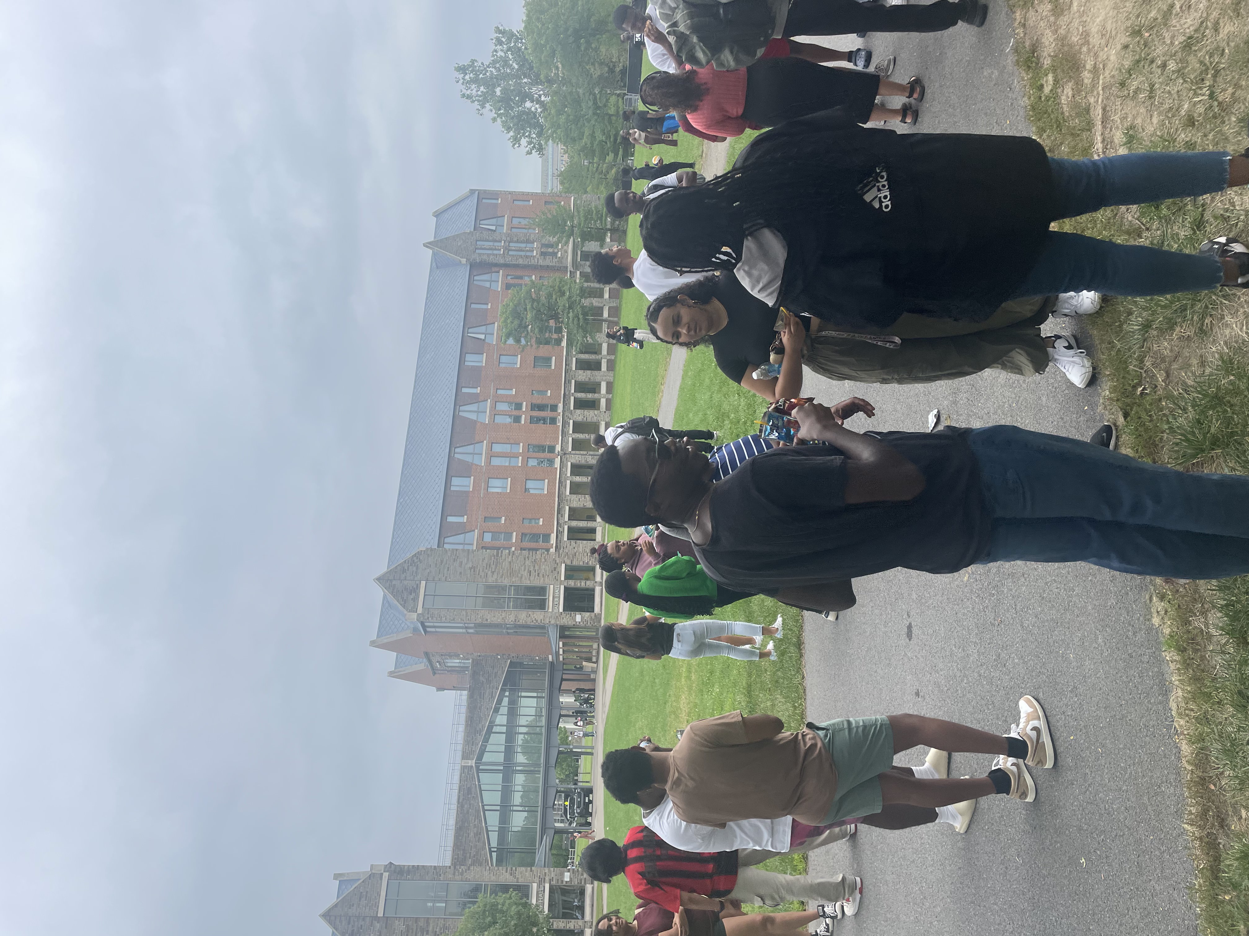 This image slider contains images of NSBE-CU's Welcome Back Barbeque. The first image of this slider displays several NSBE members speaking amongst each other within multiple groups, all standing in the field directly outside of a Cornell dorm.